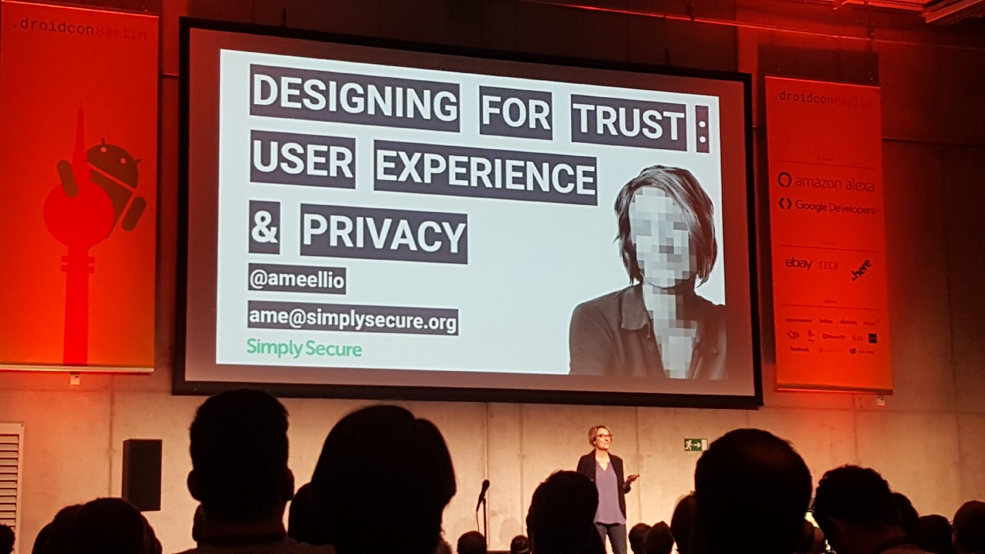 Photo shows the speaker and the title slide of the keynote talk